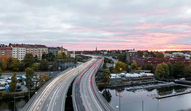 A high-traffic bridge at sunrise.