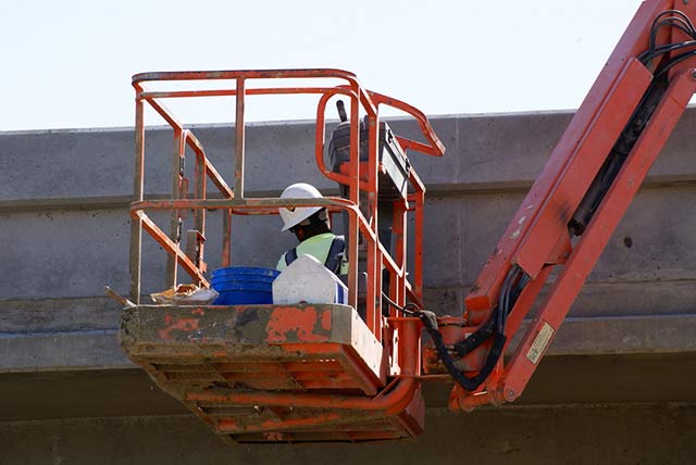 Man inspecting a bridge after drone inspections uncovered an issue.