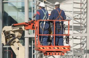 Workers with harnesses to comply with OSHA regulations