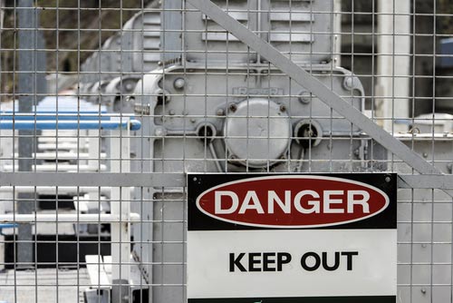 Fencing and signage in front of machinery per OSHA regulations.