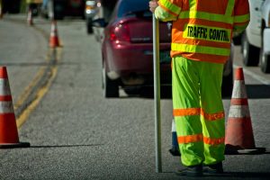 Road worker directing traffic through a construction area