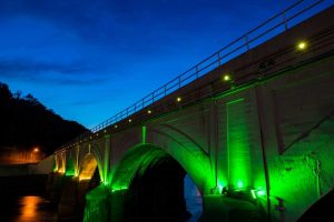 Stone Bridge glows with green light.